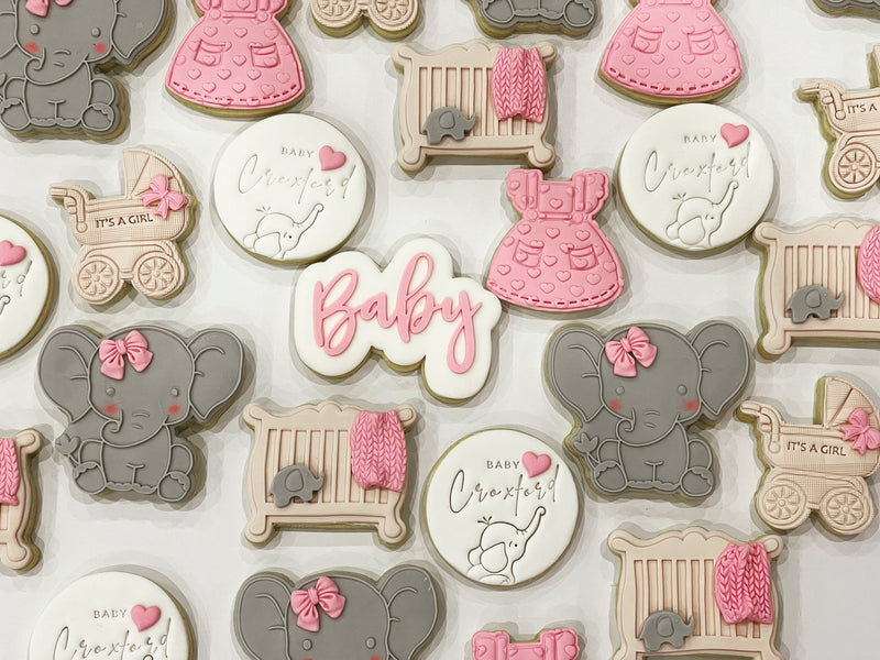 Elephant Baby Shower Cookies with Light Brown Cot Cookies, Pink Dress Cookies and white Personalised Cookies