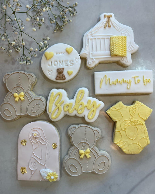 Gender Neutral Yellow Cookies with Baby Stamp Cookie and Rectangle Mummy to be cookie stamp.  Brown bear with Yellow Ribbon and Baby Yellow cookie below named baby cookie