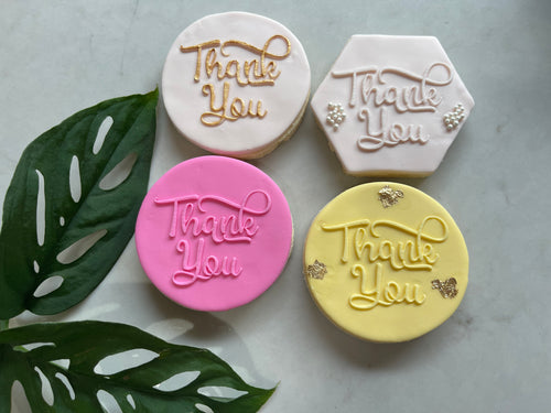 Circle White Thank you Cookie next to Hexagon White Thank you Cookie with Sprinkles.  Pink circle Thank you cookie next to Yellow Thank you Cookies with Gold Leaf