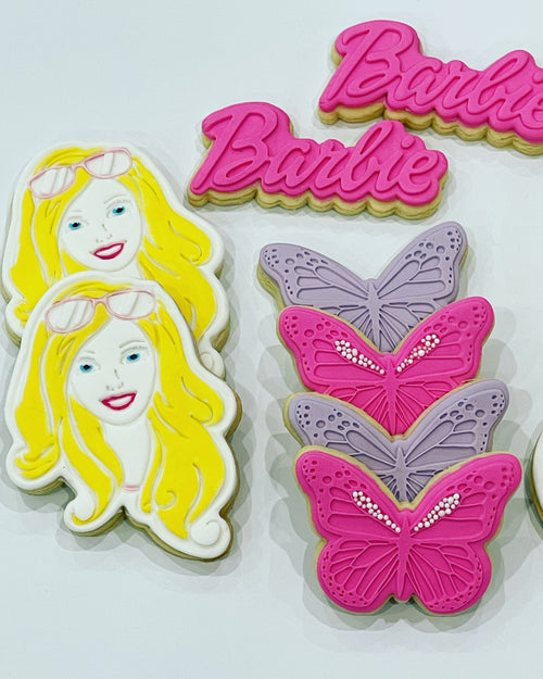 Yellow Barbie cookie with pink and purple butterflies